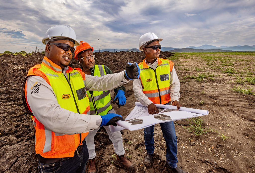 Amandelbult - Open Pit Rehabilitation. L to R are Abram Mosothoane (Site manager - Zizwe), Edgar Chandomba (Production Manager - Anglo)and Bongani Phakathi (Senior Foreman - Zizwe)